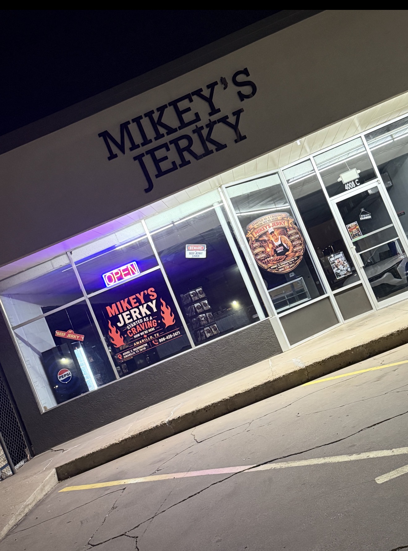 Mikey's Jerky storefront in Amarillo, TX at night
